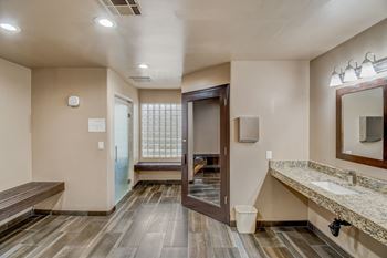 A bathroom with a wooden floor and a marble counter.